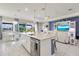 Well-lit kitchen island with stainless steel appliances and an adjacent dining area, ideal for cooking and entertaining at 629 Ibiza Loop, Venice, FL 34292