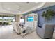 Bright living room with a feature wall, entertainment center, and outdoor view at 629 Ibiza Loop, Venice, FL 34292
