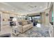 Bright living room with modern furnishings, blue accents, and access to the outdoor patio at 629 Ibiza Loop, Venice, FL 34292