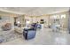 Open-concept layout with a living area, kitchen, and dining space in a well-lit area at 629 Ibiza Loop, Venice, FL 34292