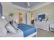 Bright main bedroom with blue ceiling, en-suite bathroom, and decorative accents at 629 Ibiza Loop, Venice, FL 34292