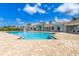 Community pool with inviting blue water, deck chairs and a nearby recreation center at 629 Ibiza Loop, Venice, FL 34292
