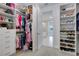Walk-in closet with clothing and shoe racks and a view into the adjoining bathroom at 629 Ibiza Loop, Venice, FL 34292