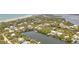 Expansive aerial shot showcases a tranquil waterfront community with beautiful homes, lush greenery, and serene waterways at 63 Palm Dr, Placida, FL 33946