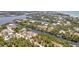 Aerial view of the property showing waterfront homes with boats docked, lush tropical surroundings, and serene waterways at 63 Palm Dr, Placida, FL 33946