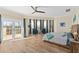 This airy bedroom features wood floors, blue accents, and a balcony at 63 Palm Dr, Placida, FL 33946