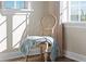 A well lit corner shows a blanket on an accent chair near the window at 63 Palm Dr, Placida, FL 33946