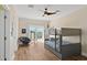 This bedroom features a gray bunk bed, wood-look floors, and a door to a small balcony at 63 Palm Dr, Placida, FL 33946