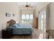 This light filled bedroom has wood floors, a ceiling fan, and balcony access at 63 Palm Dr, Placida, FL 33946