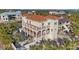 Stunning waterfront home featuring a Spanish tile roof, multiple balconies, and a private pool surrounded by lush palm trees at 63 Palm Dr, Placida, FL 33946