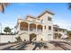 Charming three-story home with multiple balconies, white pillars, and a garage at 63 Palm Dr, Placida, FL 33946