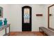 Inviting entryway with terra cotta floors, decorative door, and bench seating at 63 Palm Dr, Placida, FL 33946