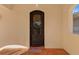 Wrought-iron front door with terra cotta tile entryway and decorative welcome mat at 63 Palm Dr, Placida, FL 33946