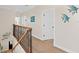 Upstairs hallway featuring wood floors, white walls and decorative wall hangings at 63 Palm Dr, Placida, FL 33946