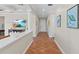 Hallway featuring terra cotta tile floors, decorative pillars, and white trim at 63 Palm Dr, Placida, FL 33946
