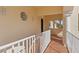 Hallway with terra cotta floors, white railings, and arched windows at 63 Palm Dr, Placida, FL 33946