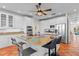 Kitchen featuring granite counters, terracotta floors, stainless appliances, and white cabinetry at 63 Palm Dr, Placida, FL 33946