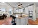 Bright kitchen with granite counters, terracotta floors, stainless steel appliances and white cabinetry at 63 Palm Dr, Placida, FL 33946
