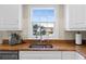 Kitchen with granite counters and stainless steel sink with double window letting in natural light at 63 Palm Dr, Placida, FL 33946