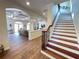 Open-concept living space featuring beamed ceilings, tile floors, elegant columns, and a staircase with wood and iron accents at 63 Palm Dr, Placida, FL 33946