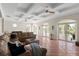 Spacious living room featuring coffered ceilings, terra cotta floors, and access to the balcony at 63 Palm Dr, Placida, FL 33946