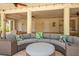 Comfortable outdoor seating area with plush cushions, ceiling fans, and travertine tile at 63 Palm Dr, Placida, FL 33946