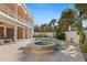 Backyard pool with tiled deck, round spa, tropical landscaping and partial view of the house at 63 Palm Dr, Placida, FL 33946