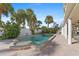 Beautiful backyard featuring a pool, spa, travertine tile, and plenty of space for entertaining in a tropical setting at 63 Palm Dr, Placida, FL 33946