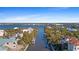 Picturesque view of a waterfront community with homes nestled along the canal and surrounded by lush tropical vegetation at 63 Palm Dr, Placida, FL 33946