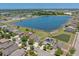 Scenic aerial view of a residential community with a picturesque lake, green spaces, and well maintained landscaping at 632 Tanana Fall Dr, Ruskin, FL 33570