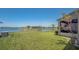 Expansive backyard with lush green lawn and waterfront views, perfect for outdoor activities and relaxation at 632 Tanana Fall Dr, Ruskin, FL 33570