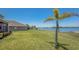 Expansive backyard with lush green lawn and waterfront views, perfect for outdoor activities and relaxation at 632 Tanana Fall Dr, Ruskin, FL 33570
