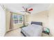 Bright bedroom with a ceiling fan, large window, and neutral decor at 632 Tanana Fall Dr, Ruskin, FL 33570
