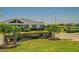 Inviting community entrance to River Bend Club with stone signage, lush landscaping, and an American flag at 632 Tanana Fall Dr, Ruskin, FL 33570