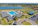 Aerial view of community pool featuring a splash pad, pool, gathering areas, and parking at 632 Tanana Fall Dr, Ruskin, FL 33570