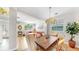 Bright dining room features a wooden table, stylish chairs, and a chandelier, with an adjoining living room at 632 Tanana Fall Dr, Ruskin, FL 33570