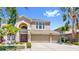 Elegant two-story home with a three car garage and well manicured lawn at 632 Tanana Fall Dr, Ruskin, FL 33570