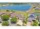 An inviting two-story home with a well-manicured lawn, complemented by a serene lake view, and solar panels at 632 Tanana Fall Dr, Ruskin, FL 33570