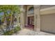 Elegant front entrance featuring double doors, decorative columns, and lush landscaping, leading to a spacious home at 632 Tanana Fall Dr, Ruskin, FL 33570