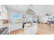 Well-lit kitchen with modern appliances, white cabinets, and an island, opens to a scenic outdoor view at 632 Tanana Fall Dr, Ruskin, FL 33570
