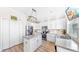 Modern kitchen equipped with white cabinets, stainless appliances, and a practical island for meal preparation at 632 Tanana Fall Dr, Ruskin, FL 33570