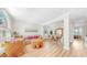 Bright living room with hardwood floors, elegant molding, and large windows offering a serene lake view at 632 Tanana Fall Dr, Ruskin, FL 33570