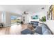 Bright living room features a modern sofa, media center, and a seamless transition to an outdoor patio at 632 Tanana Fall Dr, Ruskin, FL 33570