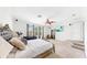 Spacious main bedroom with a ceiling fan, TV, and a comfortable seating area at 632 Tanana Fall Dr, Ruskin, FL 33570