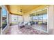 Relaxing screened patio with tile floors, ceiling fan, and comfortable seating overlooking a lush backyard at 632 Tanana Fall Dr, Ruskin, FL 33570