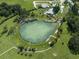 Aerial view of Warm Mineral Springs Park with a swimming lake surrounded by green space at 6497 Honeycomb Cir, North Port, FL 34291