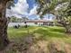Large backyard featuring an outdoor fire pit and patio area for grilling and entertaining at 6497 Honeycomb Cir, North Port, FL 34291