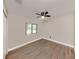 Neutral bedroom with ceiling fan and a window for natural light at 6497 Honeycomb Cir, North Port, FL 34291