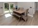 Bright dining area featuring a rustic table and chairs and view of the backyard at 6497 Honeycomb Cir, North Port, FL 34291