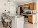 Well-lit kitchen featuring stainless steel appliances, granite countertops, and a breakfast bar with seating at 6497 Honeycomb Cir, North Port, FL 34291